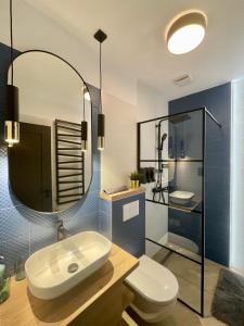 a bathroom with a sink and a toilet and a mirror at Brand New Apartment #Hollán#3BEDR#2BATHR#FREEPARKING in Budapest