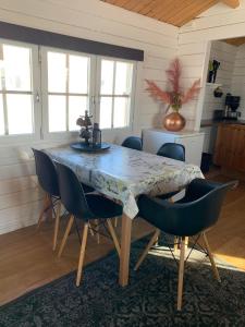 a dining room with a table and chairs at Steinnýjarstaðir in Skagaströnd +22 photos