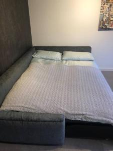 a bed with two pillows on it in a room at Brand new studio outhouse Putney SW15 in London