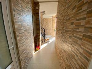 a hallway of a house with a brick wall at GUEST HOUSE OCEAN FORCE in Batumi