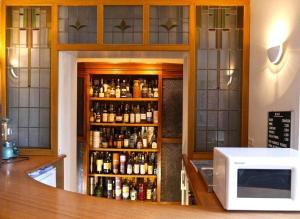 a room with a counter with bottles of alcohol at Hotel Adolesce in Amsterdam