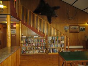 a library with a bear head on the wall at Black Cat Guest Ranch in Brule Mines