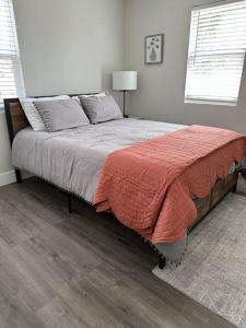 a bedroom with a bed with a red blanket on it at Modern 3 bed 1 bath Home near downtown and UNL Lincoln in Lincoln