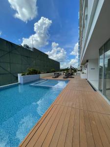 a swimming pool on the roof of a building at INSPIRIA 1803 Studio Unit with Balcony beside Abreeza Mall Davao in Davao City