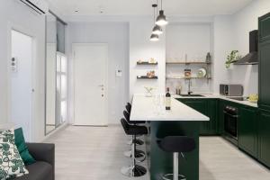 une cuisine avec des placards verts et un comptoir blanc dans l'établissement CA' LUCIA - Affitti Brevi Italia, à Milan