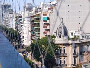 a building with a dome on top of a city at Beautiful apartment in Palermo in Buenos Aires