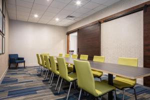 a conference room with a long table and yellow chairs at Holiday Inn Express & Suites Newport News, an IHG Hotel in Newport News