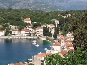 a town on a river with boats in the water at Apartments Korta in Račišće