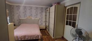 a small bedroom with a bed and a dresser at Paradise in Lankaran