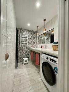 a kitchen with a washing machine in a bathroom at Апартаменти Underground&SPA in Lviv