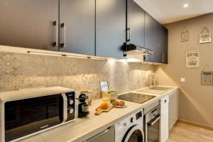 a kitchen with a sink and a microwave at Beautiful Triplex in the Center of Paris in Paris