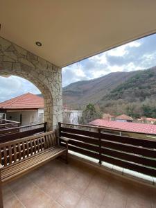 a balcony with benches and a view of mountains at VILLA RIA in Kalavrita