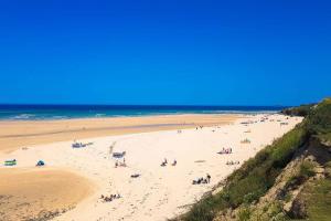 a group of people on a beach near the ocean at Sunny Corner Cottage in Hayle