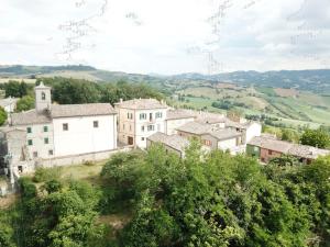 a village on a hill with houses and trees at Palazzo Minzoni in SantʼIppolito