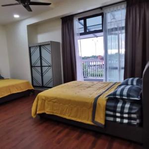 a bedroom with two beds and a large window at 88 Cozy House in Kuala Selangor