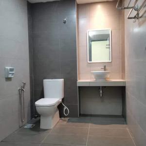a bathroom with a toilet and a sink at 88 Cozy House in Kuala Selangor +13 photos