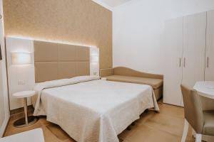 Postel nebo postele na pokoji v ubytování Hotel Gabriella