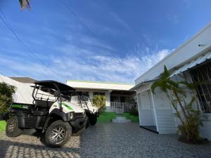 a golf cart parked in front of a house at Posada Turística Miss Geidy in San Andrés