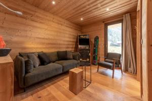 a living room with a couch and a chair at Chalet les 3 cerfs in Les Contamines-Montjoie