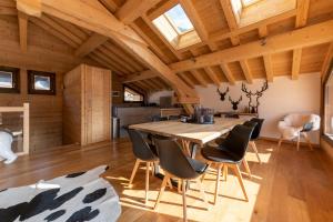 a kitchen and dining room with a wooden table and chairs at Chalet les 3 cerfs in Les Contamines-Montjoie