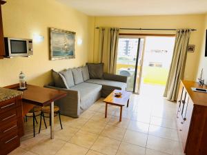 a living room with a couch and a table at Pier View Los Cristianos Free WiFi in Los Cristianos