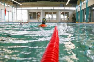 a group of people swimming in a swimming pool at Villa Duinberg R-002 in Koksijde
