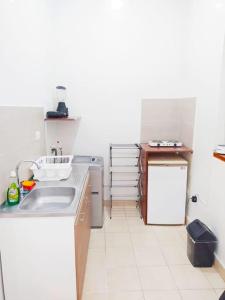 a small kitchen with a sink and a refrigerator at apartamento centro histórico 303-1 in Cartagena de Indias