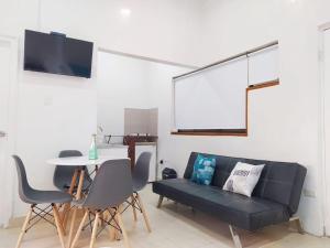 uma sala de estar com um sofá preto e uma mesa em apartamento centro histórico 303-1 em Cartagena das Índias