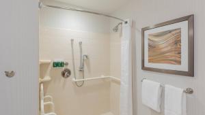 a bathroom with a shower and a toilet with towels at Courtyard by Marriott Greenville Downtown in Greenville