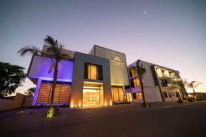 a building with purple lights on the front of it at Marigold Hotels in Windhoek