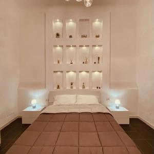 a bedroom with a large bed with two tables at Dimora Falcone in Bari