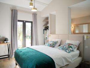 a bedroom with a large bed with a window at Maison d'Hôtes L'Espigoulié in Sainte-Maxime