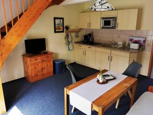 a kitchen and dining room with a table and a kitchen at Ferienhof Rausch in Rathenow