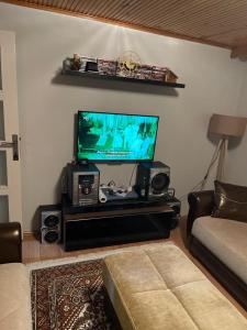 a living room with a flat screen tv and speakers at Zeytinburnu in Istanbul