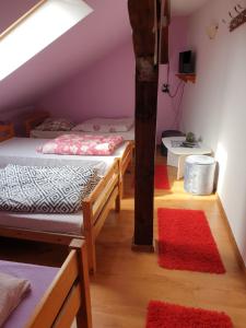 a room with two beds and a table at Agroturystyka Świerki in Lubawka