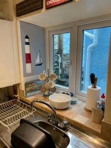 a kitchen counter with a sink and a window at Bryn Goleu, Mersey Street, Borth-y-Gest in Porthmadog
