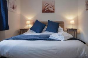 a bedroom with a bed with blue pillows at Sea Breeze Apt 3 - 2 Bedroom - Horton Beach in Horton