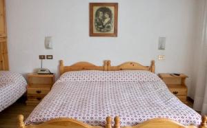 Postel nebo postele na pokoji v ubytování Albergo Piani di Luzza