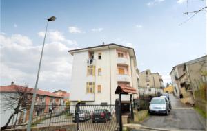 a white building with cars parked in front of it at 4 Bedroom Stunning Apartment In Rogliano in Rogliano