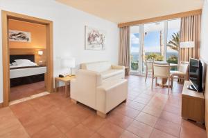 a hotel room with a bed and a living room at Esencia de Fuerteventura by Princess in Playa Jandia