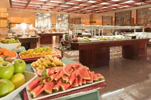 a buffet line with fruits and vegetables in a restaurant at Mogan Princess & Beach Club in Taurito