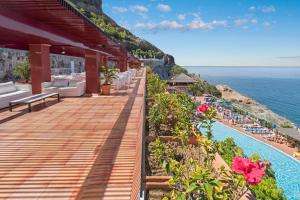 a resort deck with a view of the ocean at Mogan Princess & Beach Club in Taurito