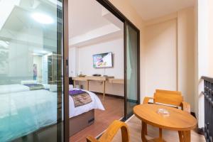 TV a/nebo společenská místnost v ubytování Peacock De Pai Hotel