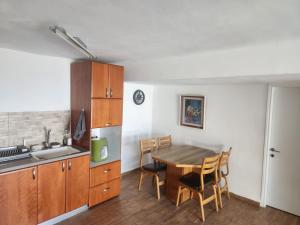 a kitchen with a table and chairs in a room at Beit Nofesh in Tiberias