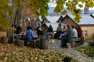 people are gathered around a picnic table at The Porches Inn at Mass MoCA in North Adams