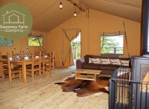 a living room with a couch and a table at Sweeney Farm Glamping in Oswestry
