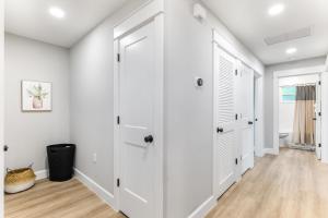 an empty hallway with white walls and white doors at Brand New Bungalow with King Bed Suites in St Aug in Saint Augustine