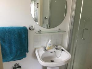 a bathroom with a sink and a mirror at Victoria's house in Kells