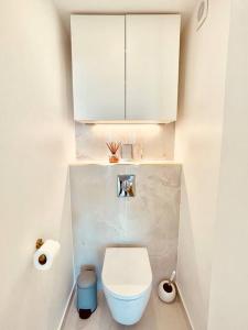 a white bathroom with a toilet and a white cabinet at Superbe 50m² calme et élégant, proche Paris in Villejuif