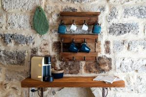 a wall with a wooden shelf with a toaster at Suite Torre Arcobasso in Bari